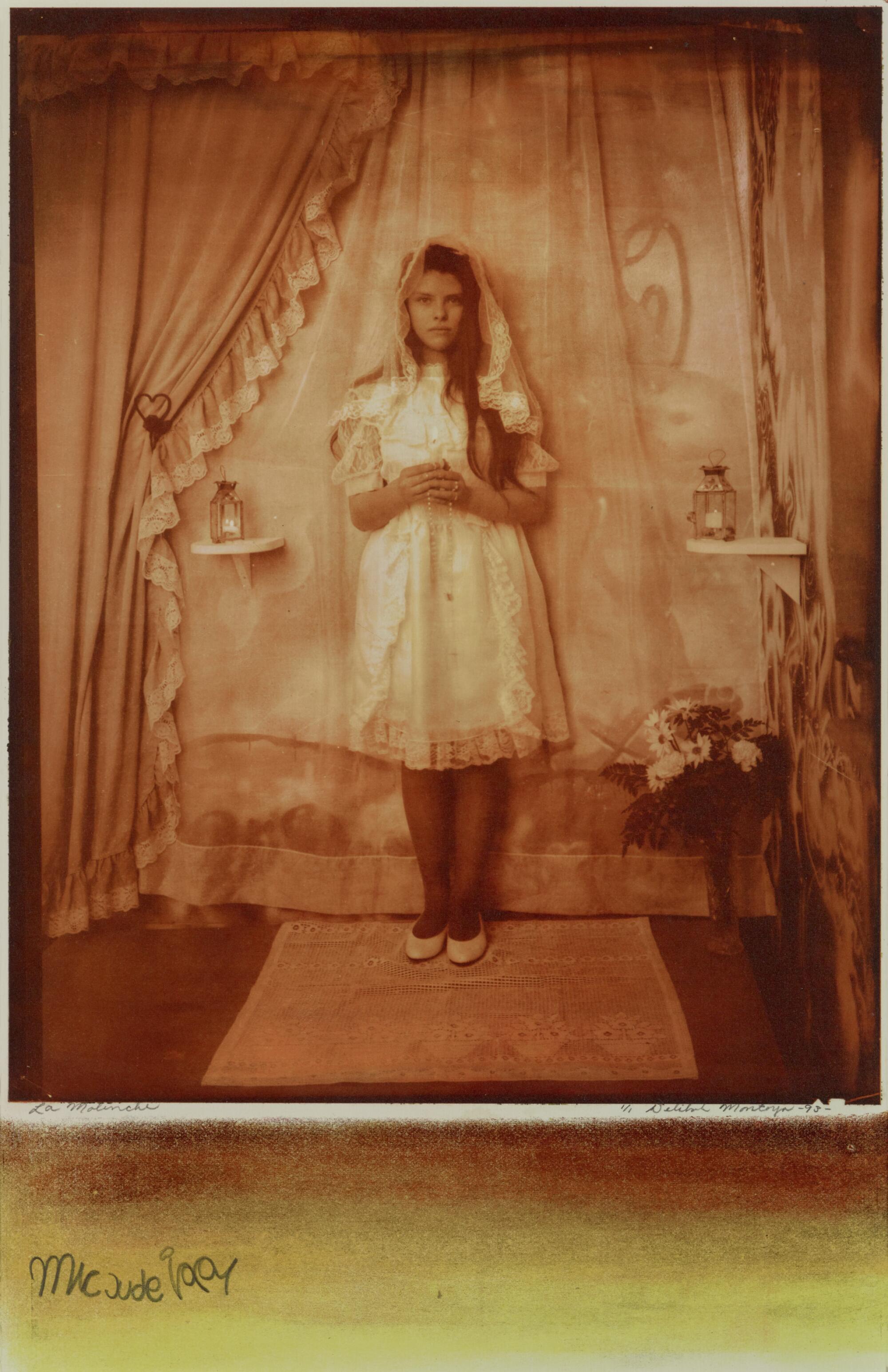 A sepia toned image shows a young girl in First Communion dress and a veil