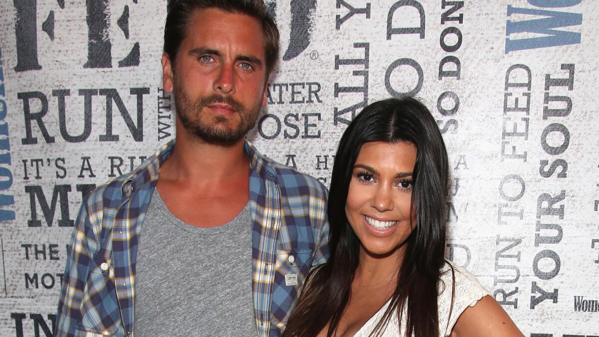 Kourtney Kardashian, shown with Scott Disick in August 2014, has reportedly welcomed the father of her three kids back into the "family unit."