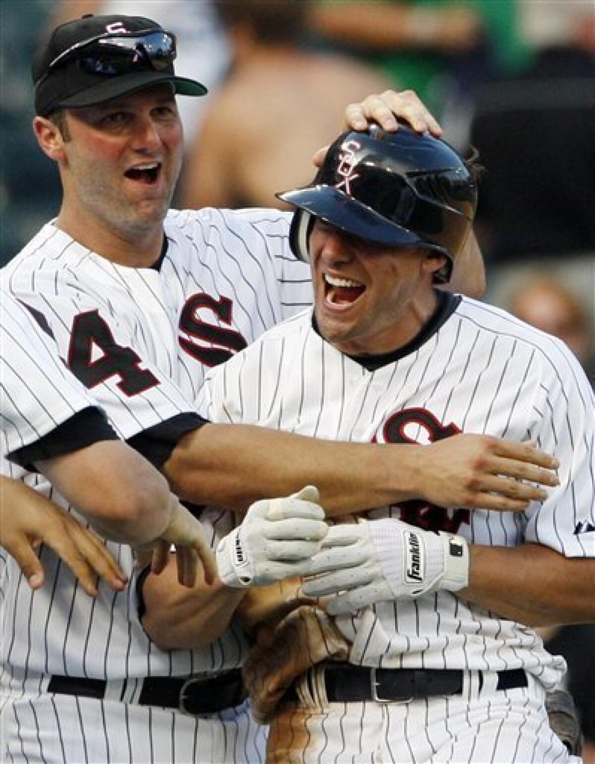FILE - In this June 25, 2009, file photo, Chicago White Sox's Scott Podsednik, right, celebrates with Paul Konerko after Podsednik drove in the winning run against the Los Angeles Dodgers during the 13th inning of an interleague baseball game in Chicago. A Kansas City Royals spokesman said Friday, Jan. 8, 2010, that Podsednik would take a physical later Friday and possibly sign immediately afterward. Terms of the deal were not immediately known. (AP Photo/Nam Y. Huh, File)