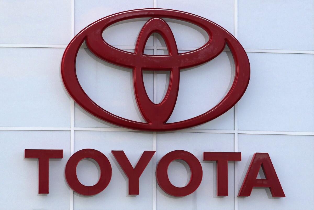This Aug. 15, 2019, file photo shows the Toyota logo on a dealership in Manchester, N.H. In a deal announced Wednesday, July 21, 2021, Japan’s top automaker Toyota is adding makers specializing in tiny “kei” cars, Daihatsu and Suzuki, to a partnership in commercial vehicles set up with Hino and Isuzu earlier this year. (AP Photo/Charles Krupa, File)