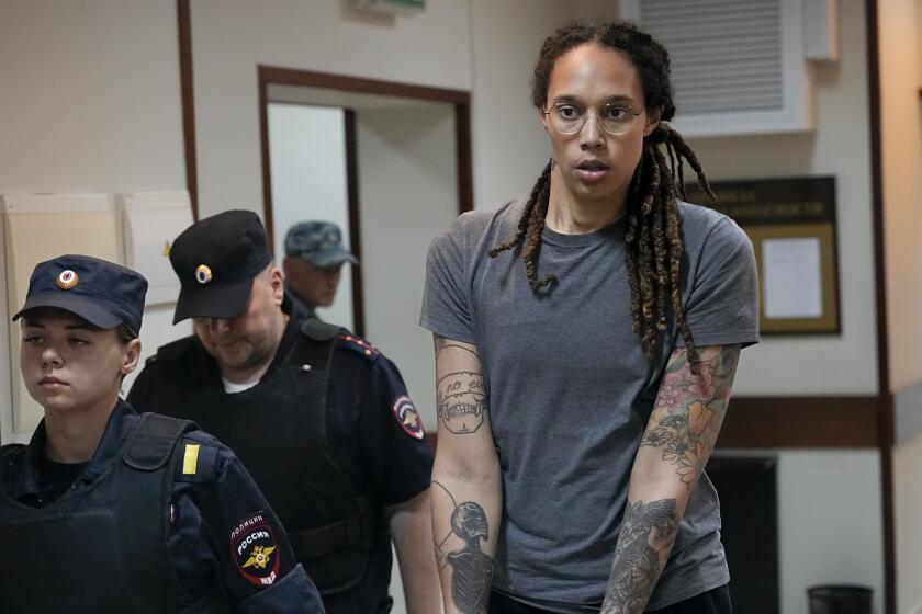 WNBA star and two-time Olympic gold medalist Brittney Griner is escorted from a courtroom on Aug. 4, 2022.