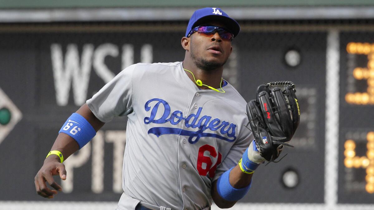 Dodgers right fielder Yasiel Puig makes a catch during Saturday's loss to the Philadelphia Phillies. Dodgers Manager Don Mattingly wants Puig to keep playing in right field.