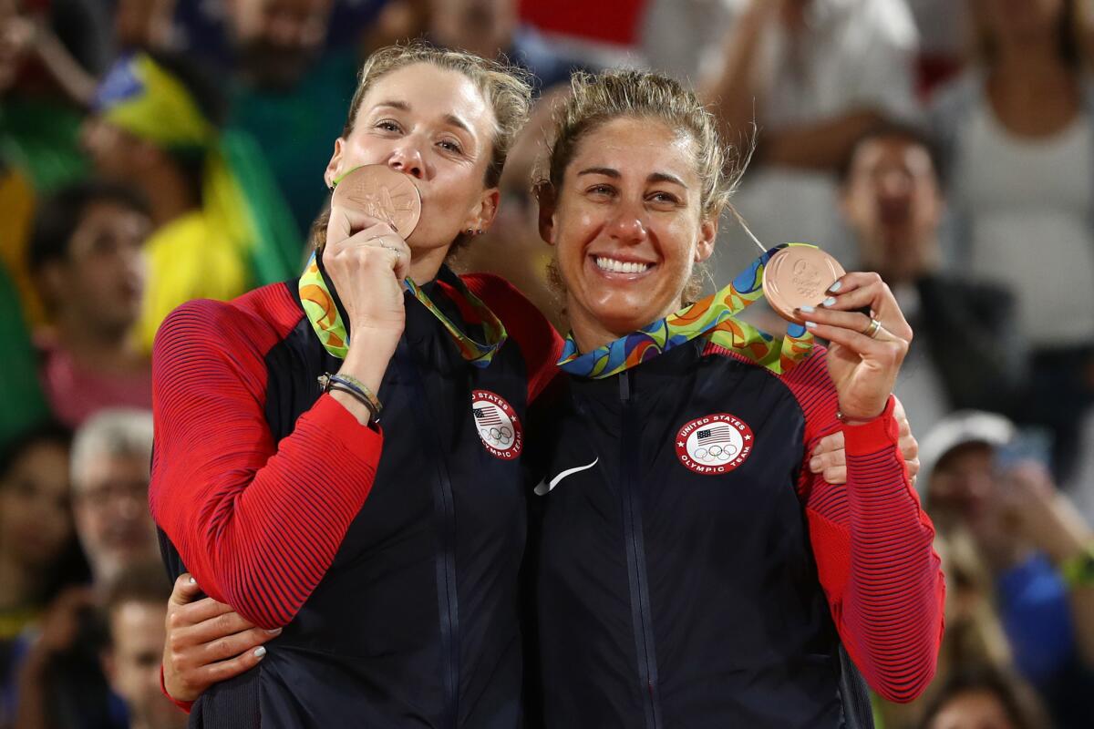 Kerri Walsh Jennings and April Ross pose after receiving their bronze medals at the Rio Olympics on Aug. 17.