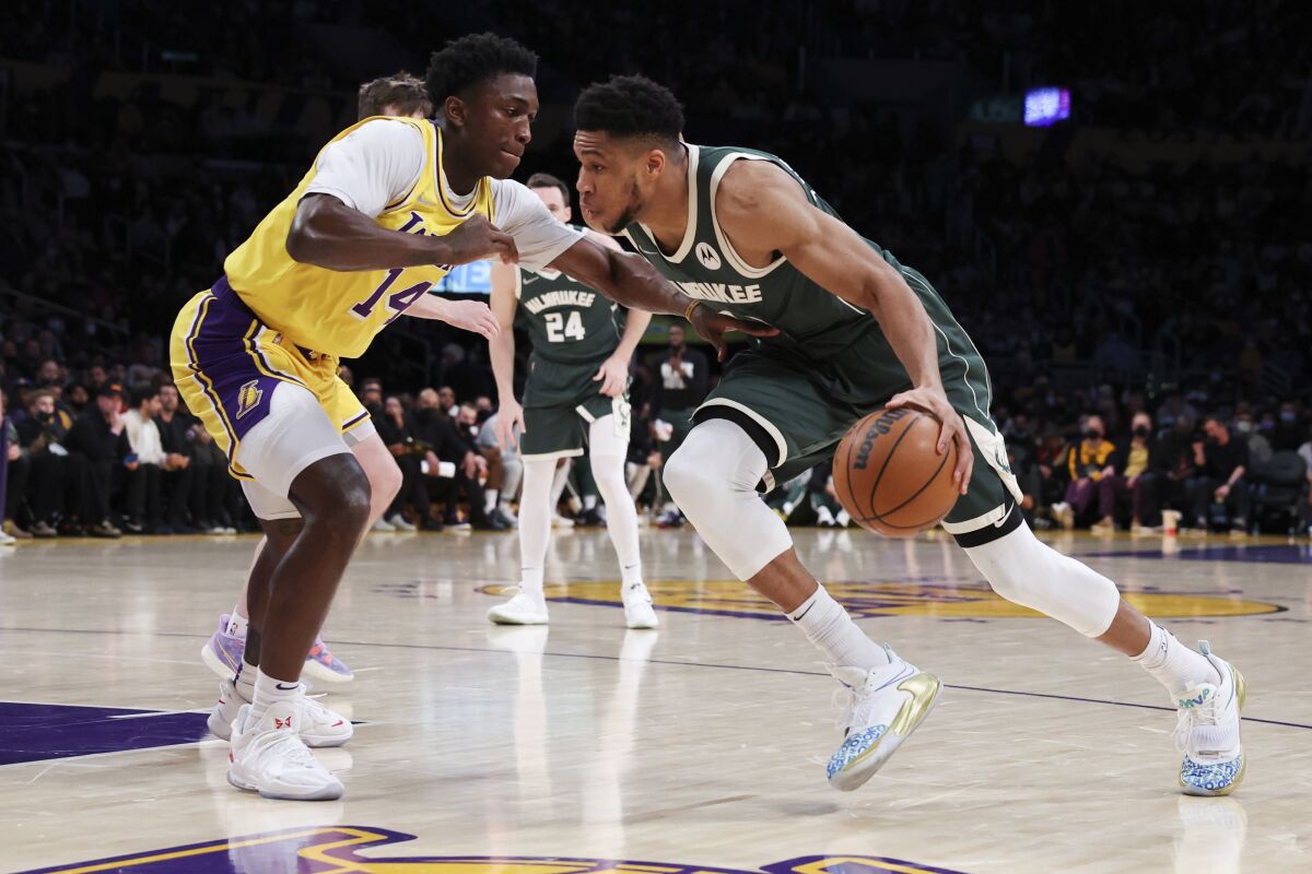 Bucks forward Giannis Antetokounmpo drives to the basket against Lakers forward Stanley Johnson.