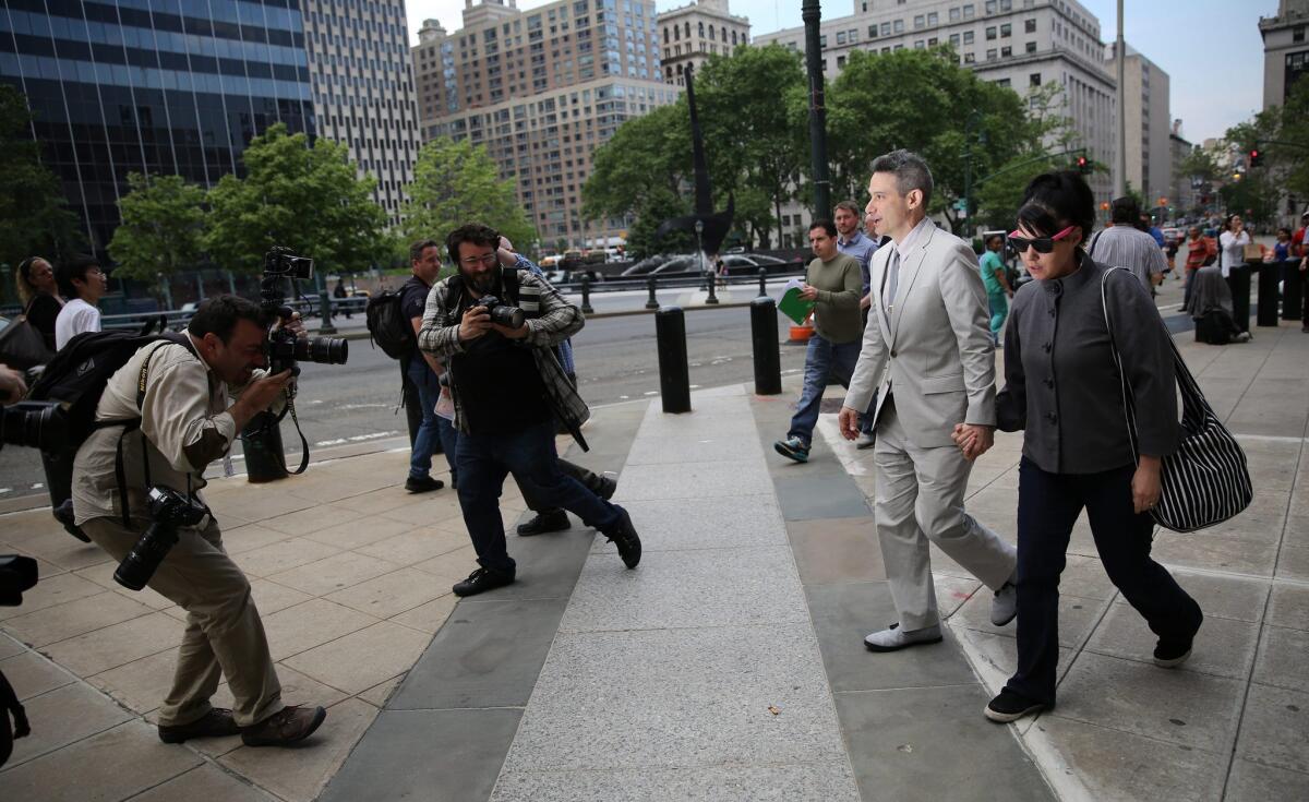 Adam "Ad-Rock" Horovitz of the Beastie Boys and his wife, Kathleen Hanna, leave court last week during trial of the band's suit against beverage maker Monster Energy Co.