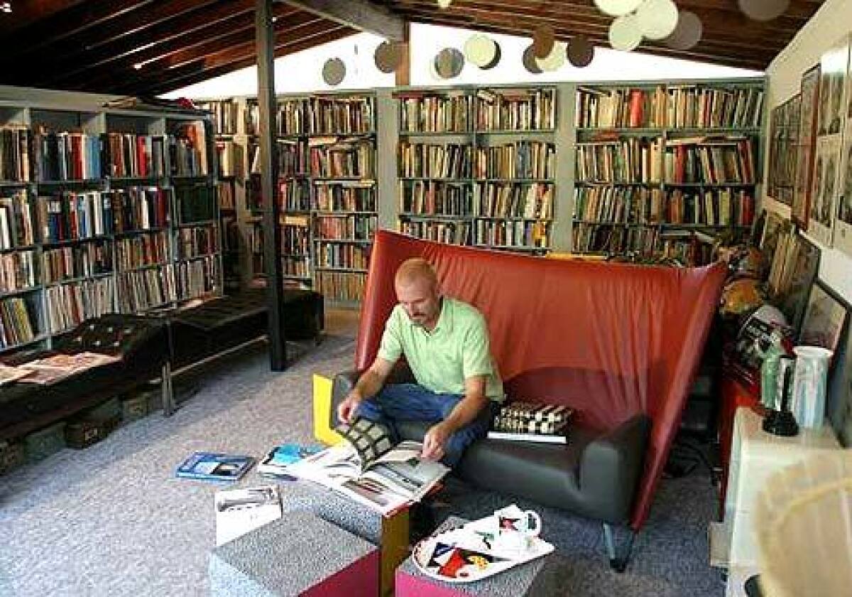 Bruce Emerton transformed the garage of his Cliff May home in Pomona into a library to hold part of his collection of 20,000 books.