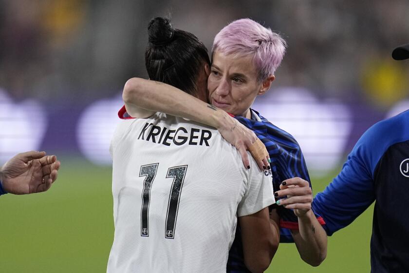 OL Reign forward Megan Rapinoe, right, embraces NJ/NY Gotham defender Ali Krieger (11) as Rapinoe comes off the field after an injury during the first half of the NWSL Championship soccer game, Saturday, Nov. 11, 2023, in San Diego. (AP Photo/Gregory Bull)