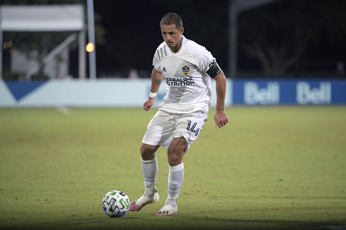 Galaxy forward Javier "Chicharito" Hernández controls the ball on the pitch.