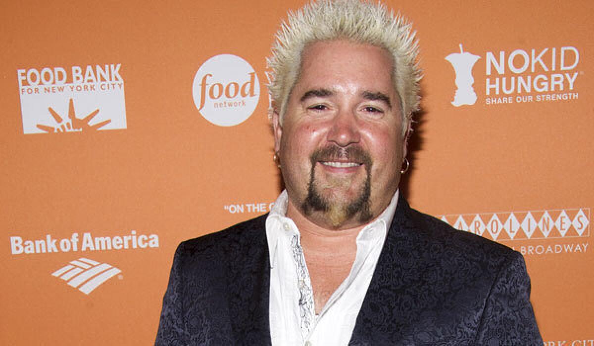 Guy Fieri, the host of "Diners, Drive-Ins and Dives," gets poor marks from the New York Times at his new restaurant.