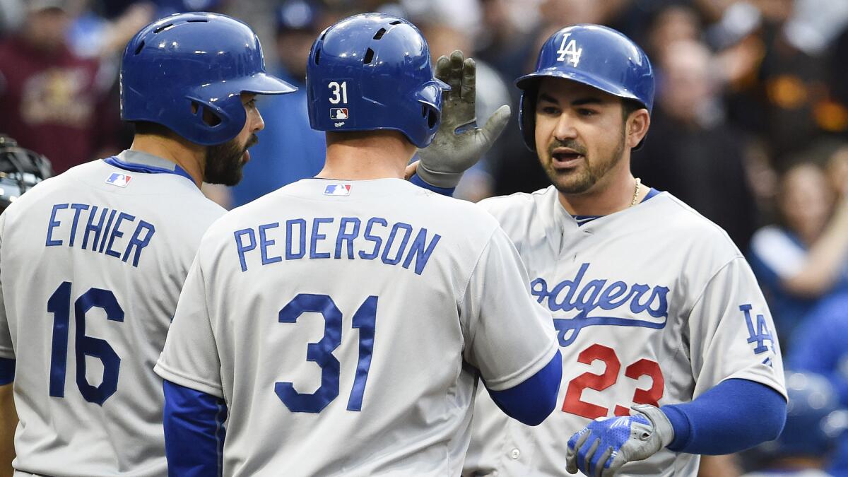Dodgers first baseman Adrian Gonzalez, right, is congratulated by teammates Andre Ethier, left, and Joc Pederson after hitting a three-run home run against the San Diego Padres on April 25.