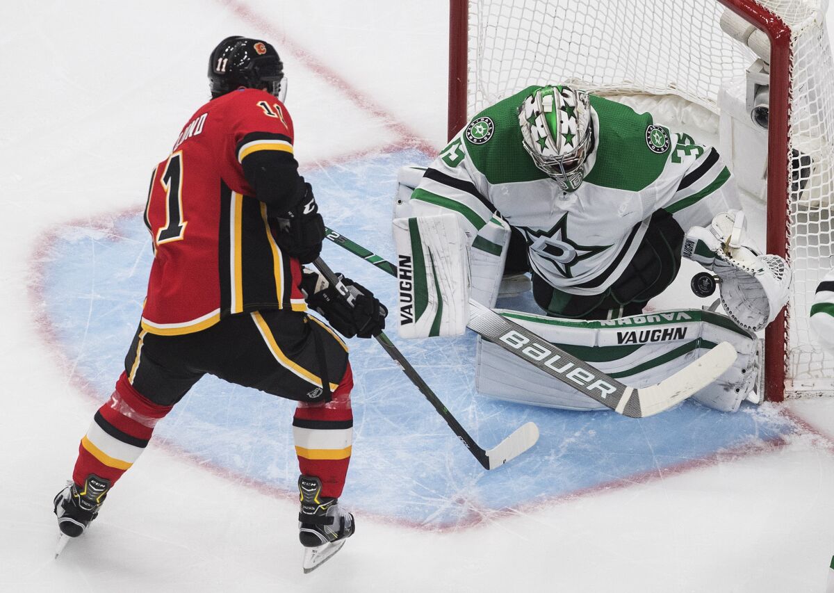 Calgary Flames' Mikael Backlund (11) scores on Dallas Stars goalie Anton Khudobin (35) during the second period in the first round NHL Stanley Cup playoff hockey series, Friday, Aug. 14, 2020, in Edmonton, Alberta. (Jason Franson/The Canadian Press via AP)
