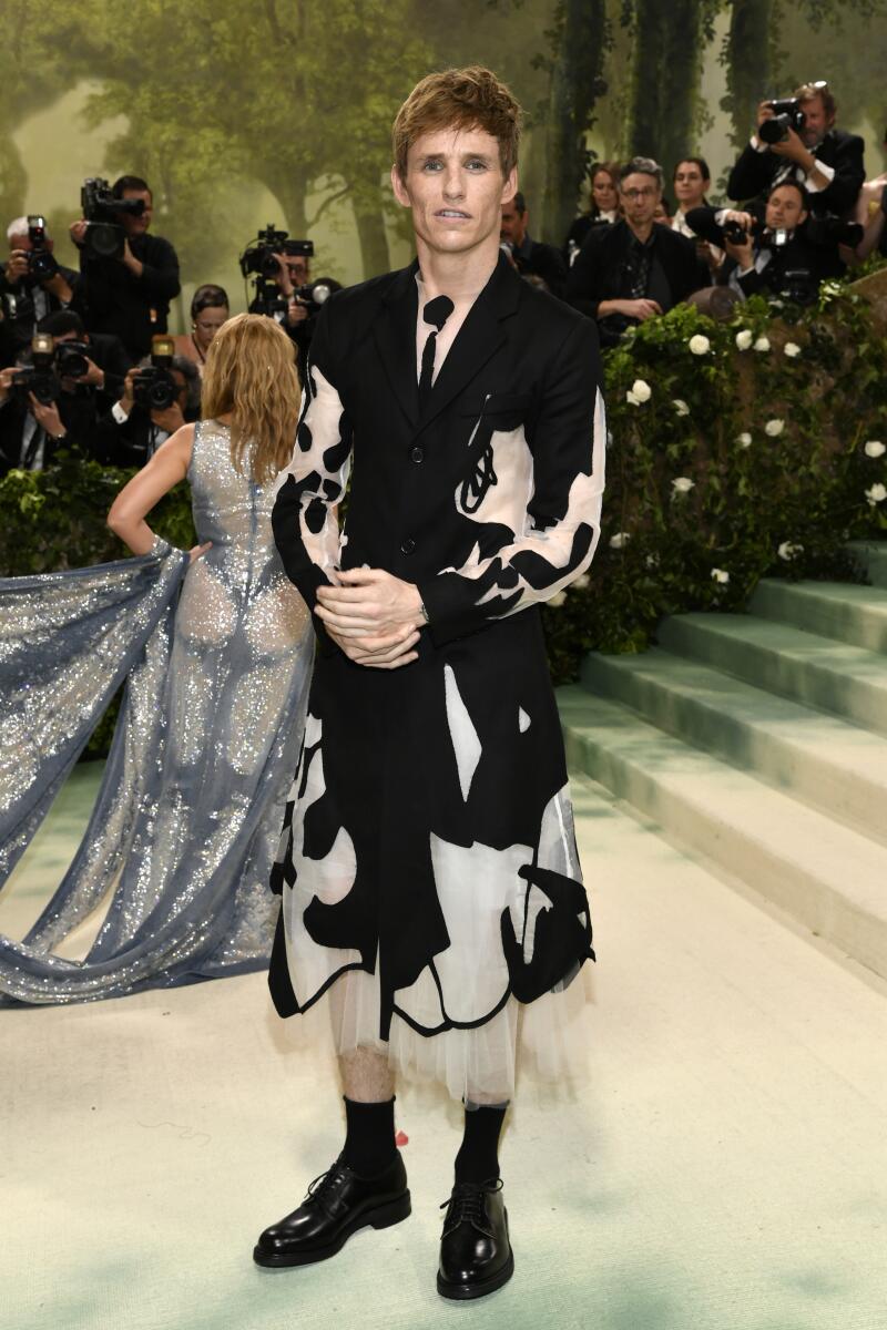 Eddie Redmayne has long flirted with his feminine side by wearing sheer and floaty fabrics; he does the same here with a layered look of black and geometric appliqués that resemble insect wings.