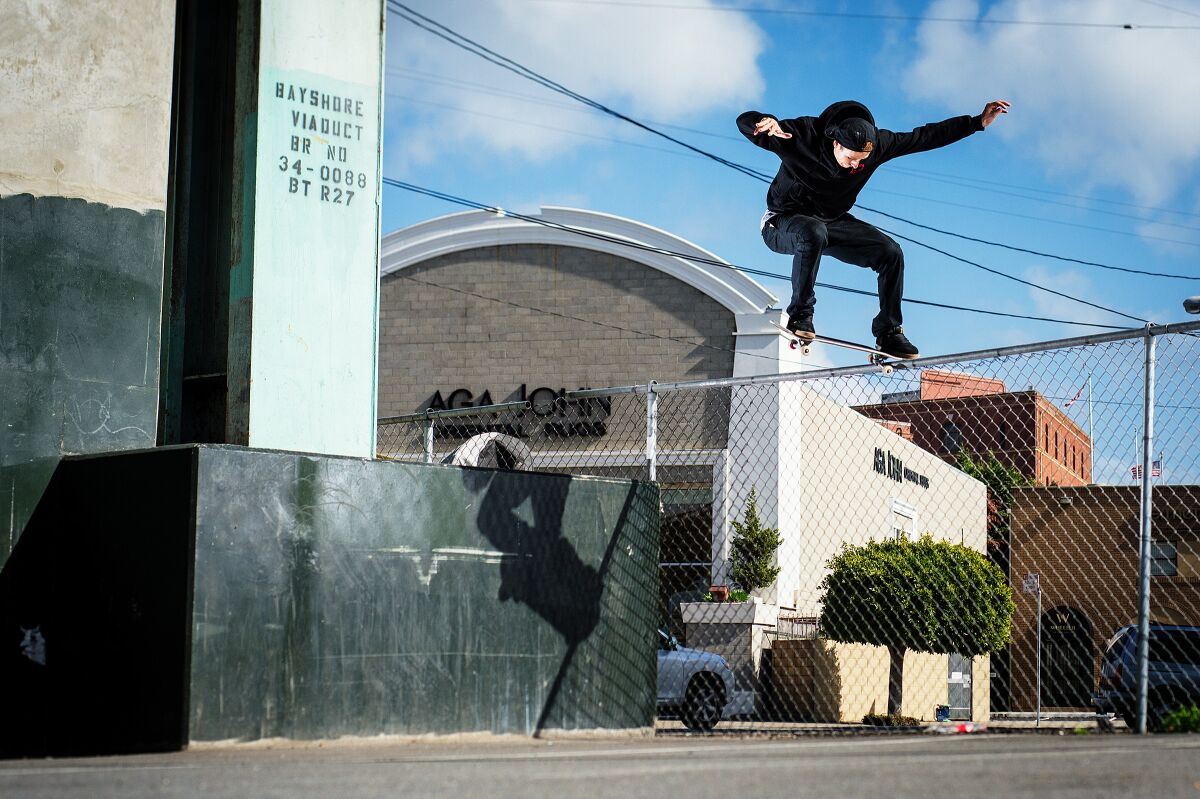 “Top of Mason” author Walker Ryan performs a skateboard trick on the streets of San Francisco.