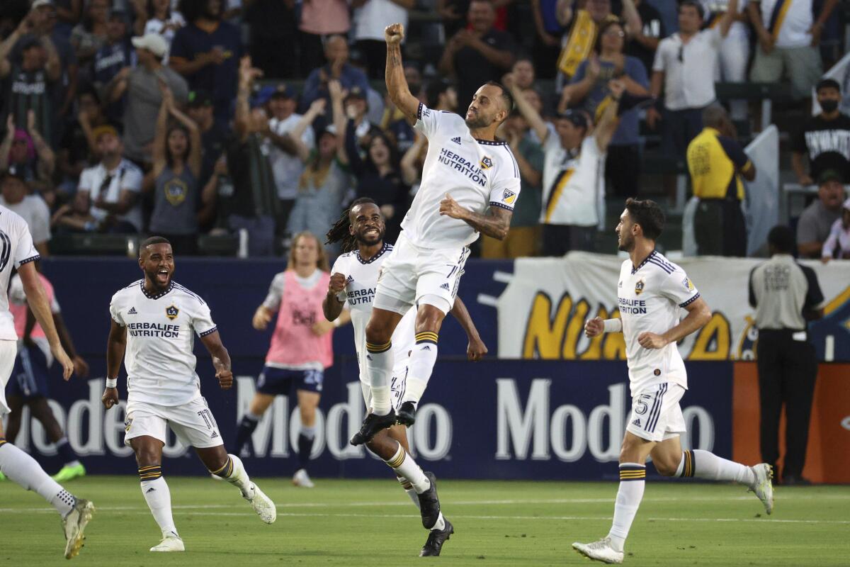 The Galaxy's Víctor Vázquez jumps after scoring a goal against the Vancouver Whitecaps on Aug. 13, 2022.
