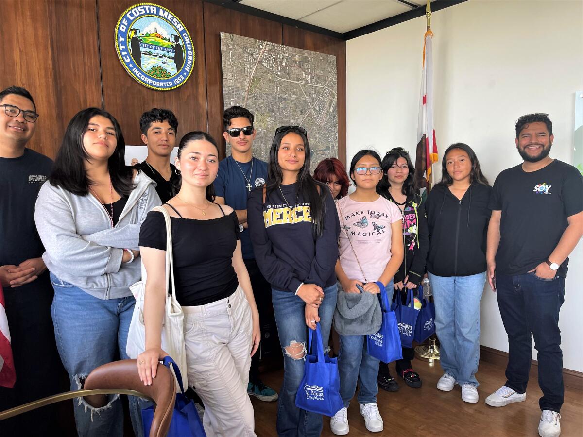 Costa Mesa Councilman Manuel Chavez, right, with students in Save Our Youth's College Corps program, in City Hall.