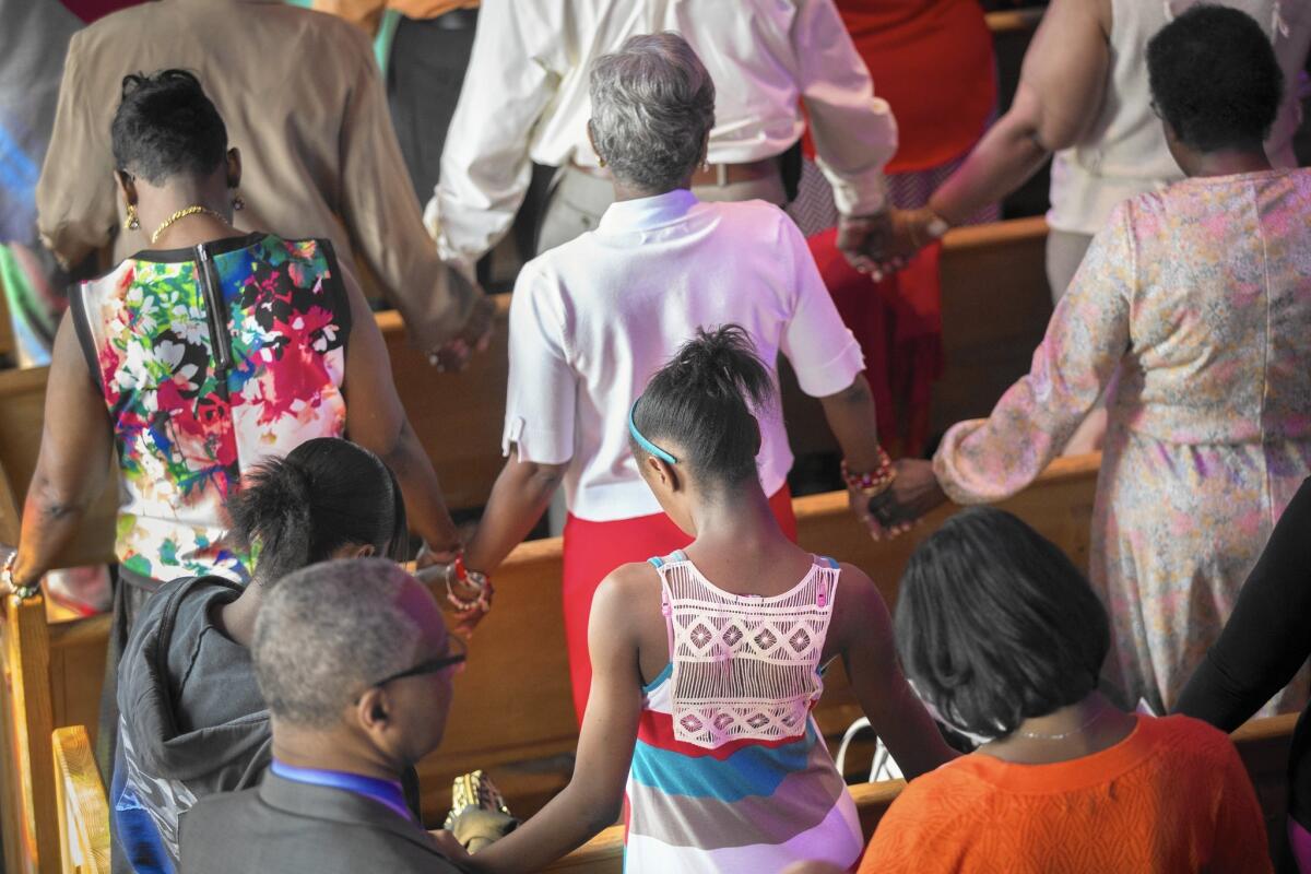 Worshipers at Olivet Institutional Baptist Church in Cleveland pray for healing on May 23, a day after Officer Michael Brelo was acquitted in the shooting death of two unarmed people at the end of car chase.