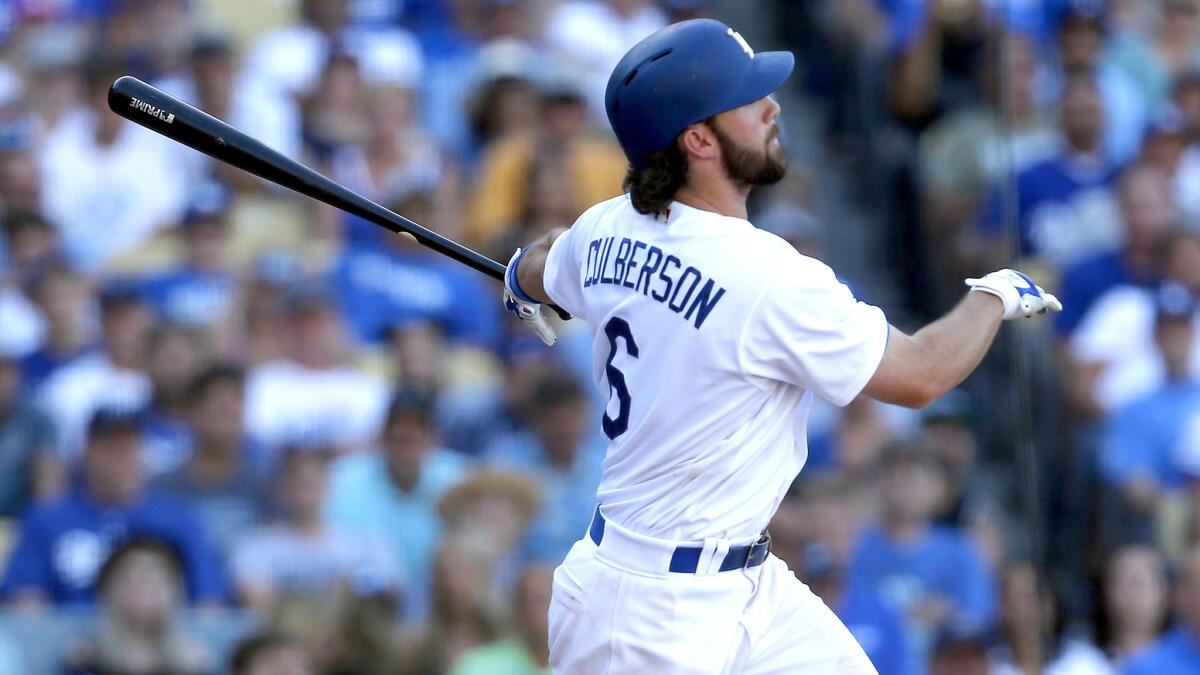 Dodgers seond baseman Charlie Culberson watches his walk-off home run against the Rockies on Sept. 25, 2016, at Dodger Stadium.