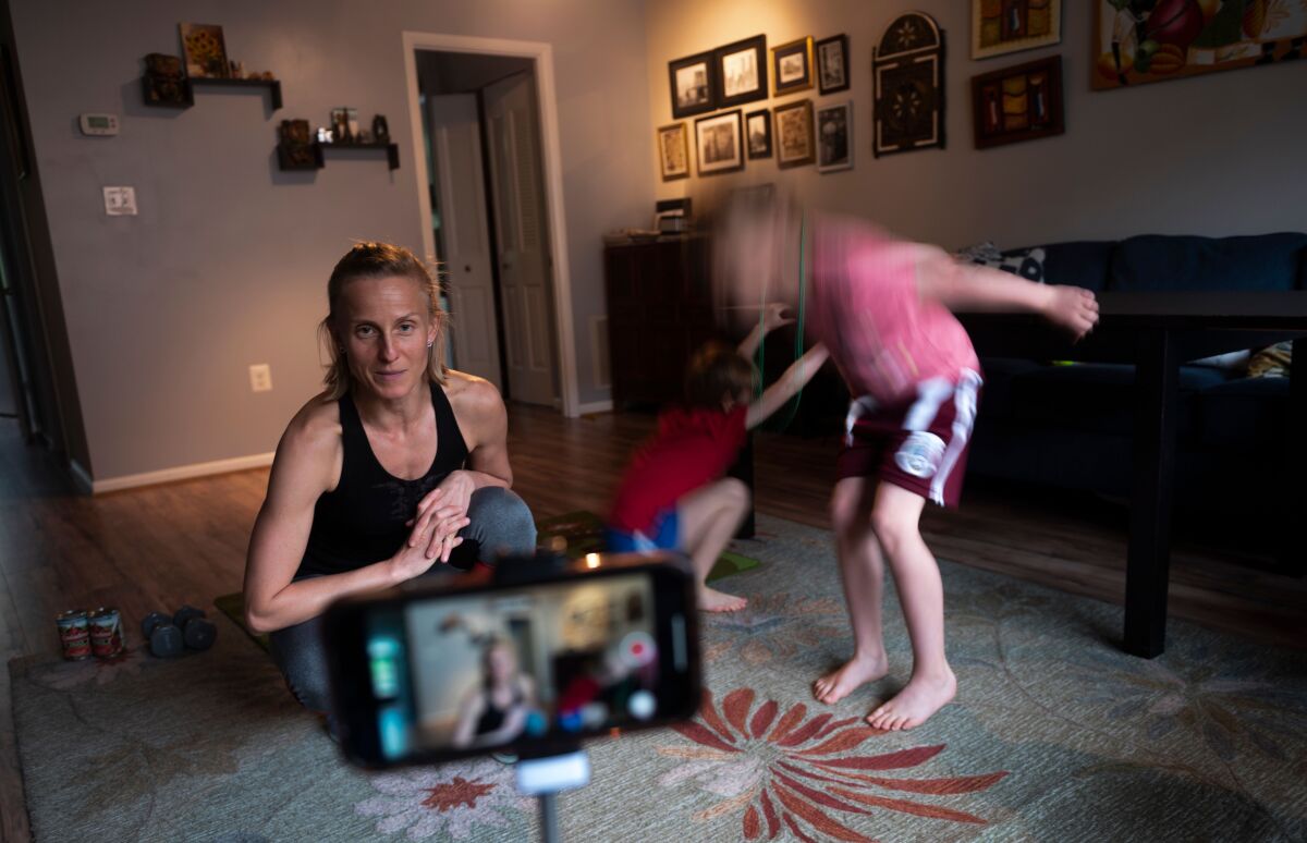 Paulina Mansz, a group fitness instructor, sets up an iPhone as she prepares to record a workout.