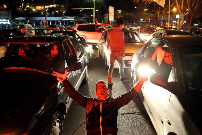 Iranians celebrate on a street in northern Tehran after Iran's preliminary nuclear agreement with world powers.