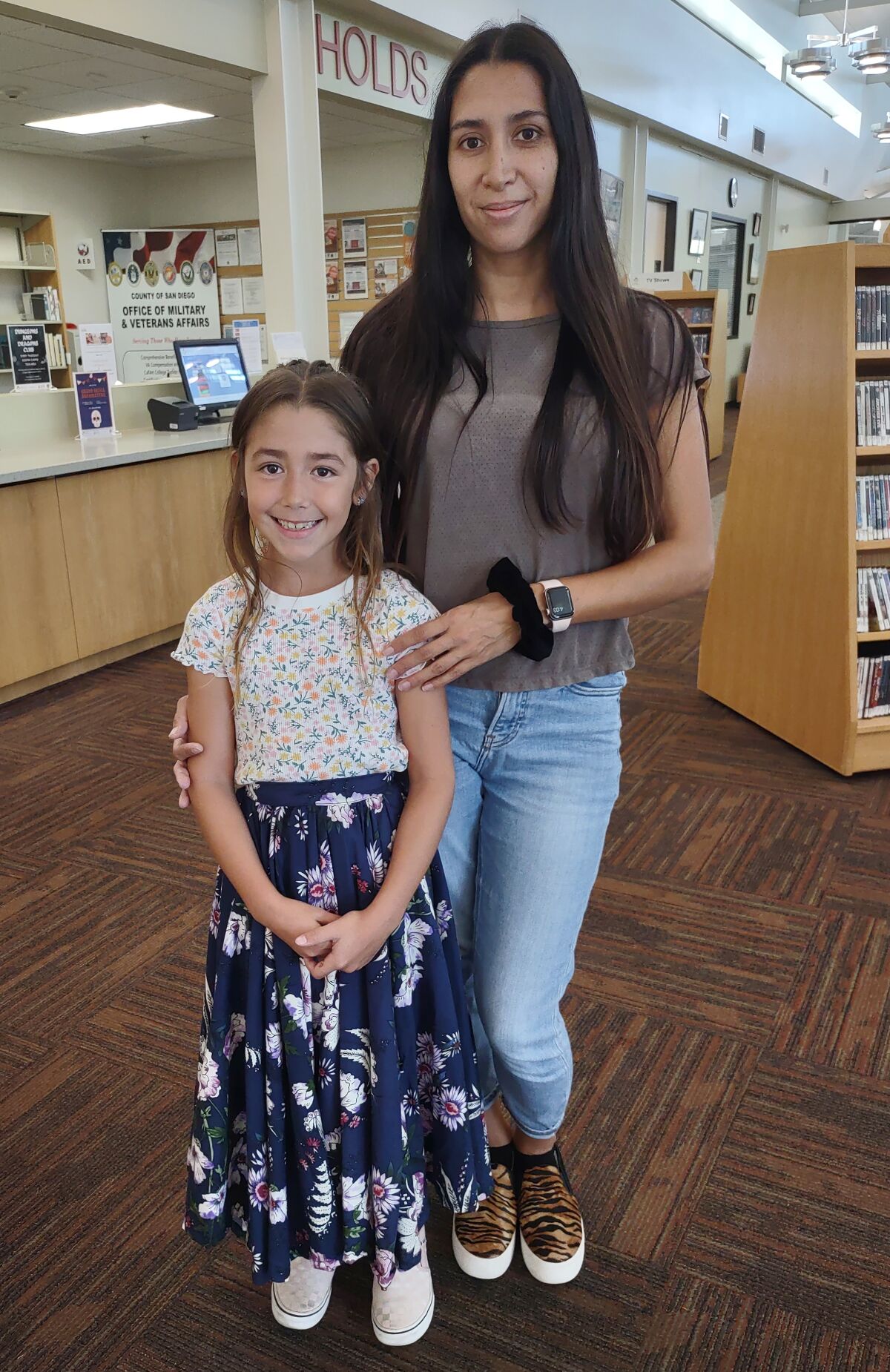 Ramona resident Katelyn Heyer, 8, prepares for her folk ballet lesson at the Ramona Library with her mother, Iris Heyer.
