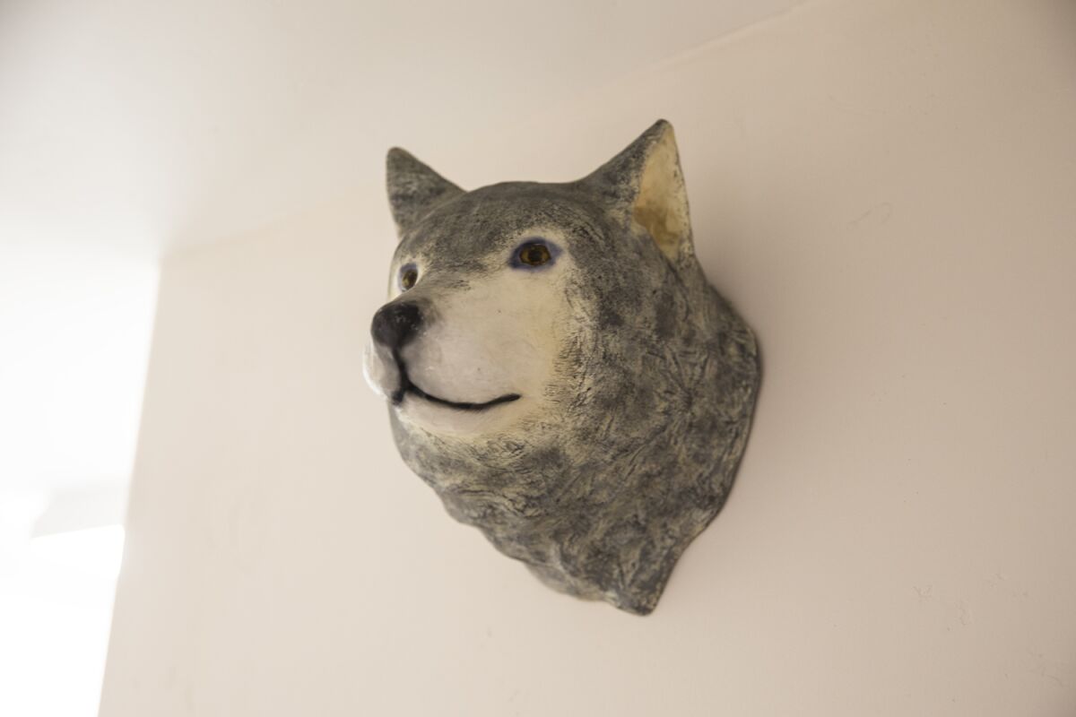 A wolf sculpture on the wall at Wolf in the Woods restaurant in Mission Hills.