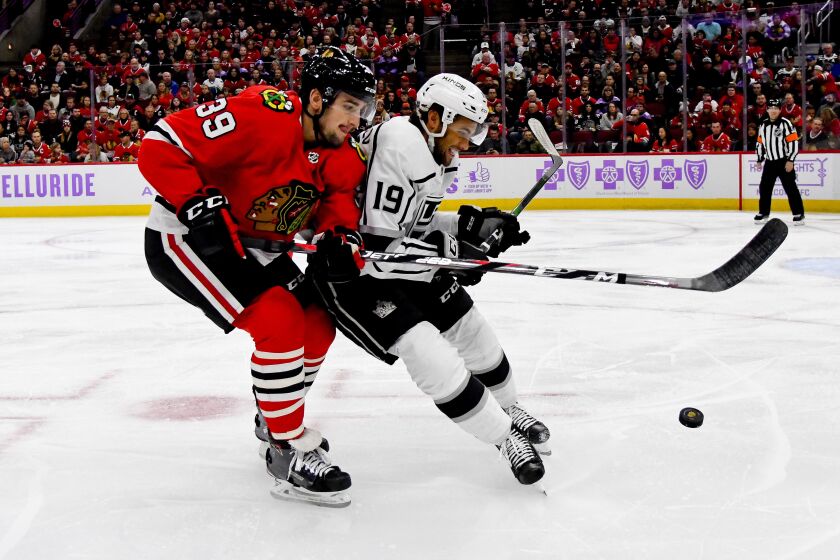 KKings left wing Alex Iafallo (19) tries to fend off Blackhawks defenseman Dennis Gilbert in a battle for possession of the puck during the first period on Oct. 27, 2019, in Chicago.