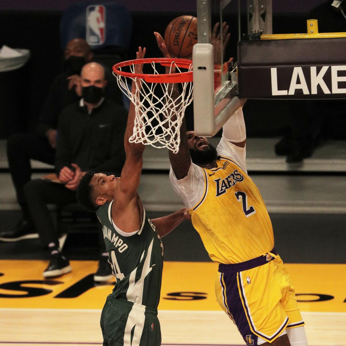 Lakers Andre Drummond drives to the basket against Milwaukee Bucks forward Giannis Antetokounmpo.