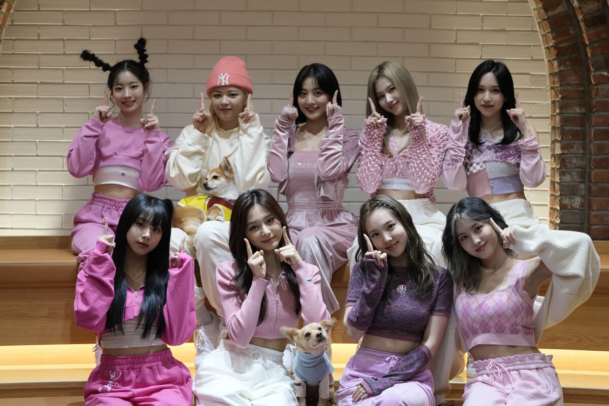 South Korean K-pop group TWICE poses for a photo after an interview in Seoul, South Korea, Wednesday, Nov. 10, 2021. TWICE, the nine-member K-pop band with over nine million Twitter followers, says they feel the growing popularity of the band and K-pop overseas. (AP Photo/Lee Jin-man)