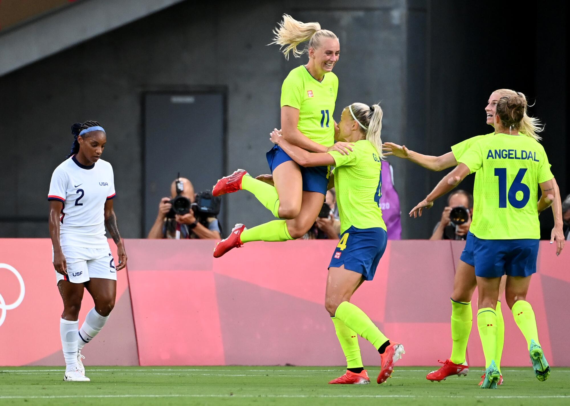 Sweden's Stina Blackstenius jumps into the arms of a teammate after scoring a goal.