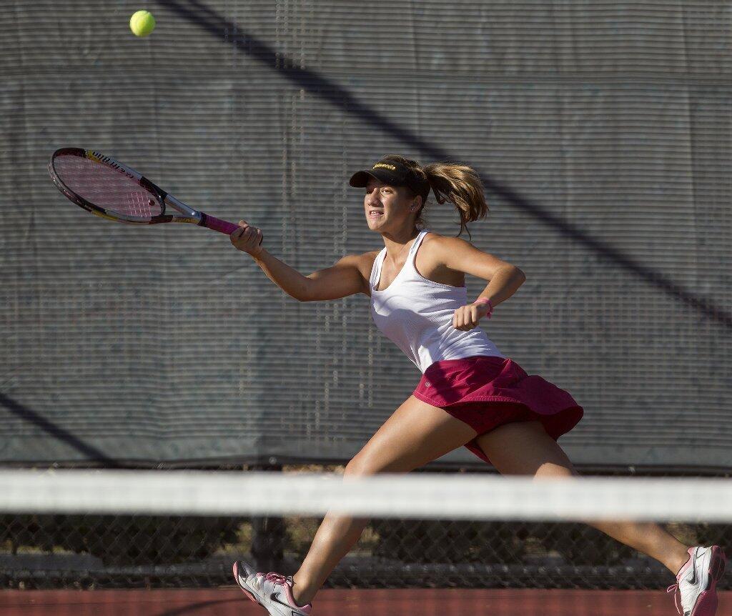 Estancia High's Delani Guyot chases down the ball during a No. 1 doubles set against Costa Mesa.