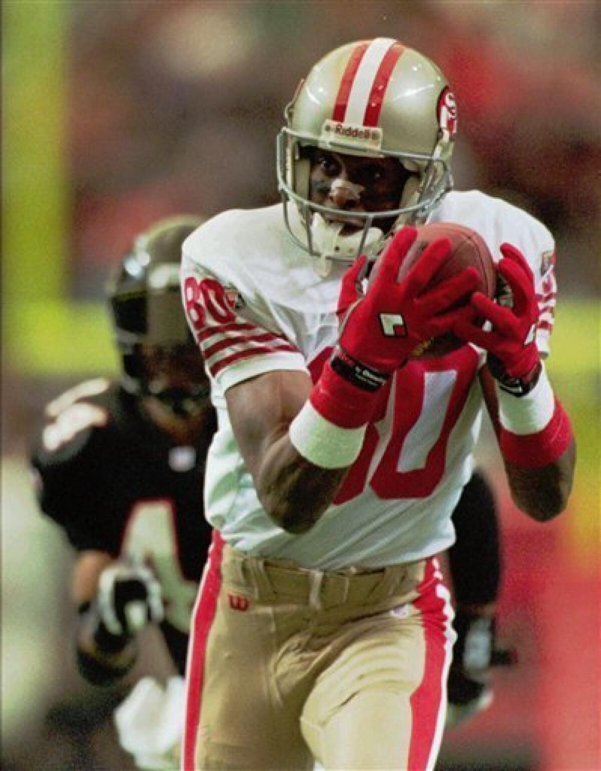 San Francisco 49ers wide receiver Jerry Rice celebrates his first