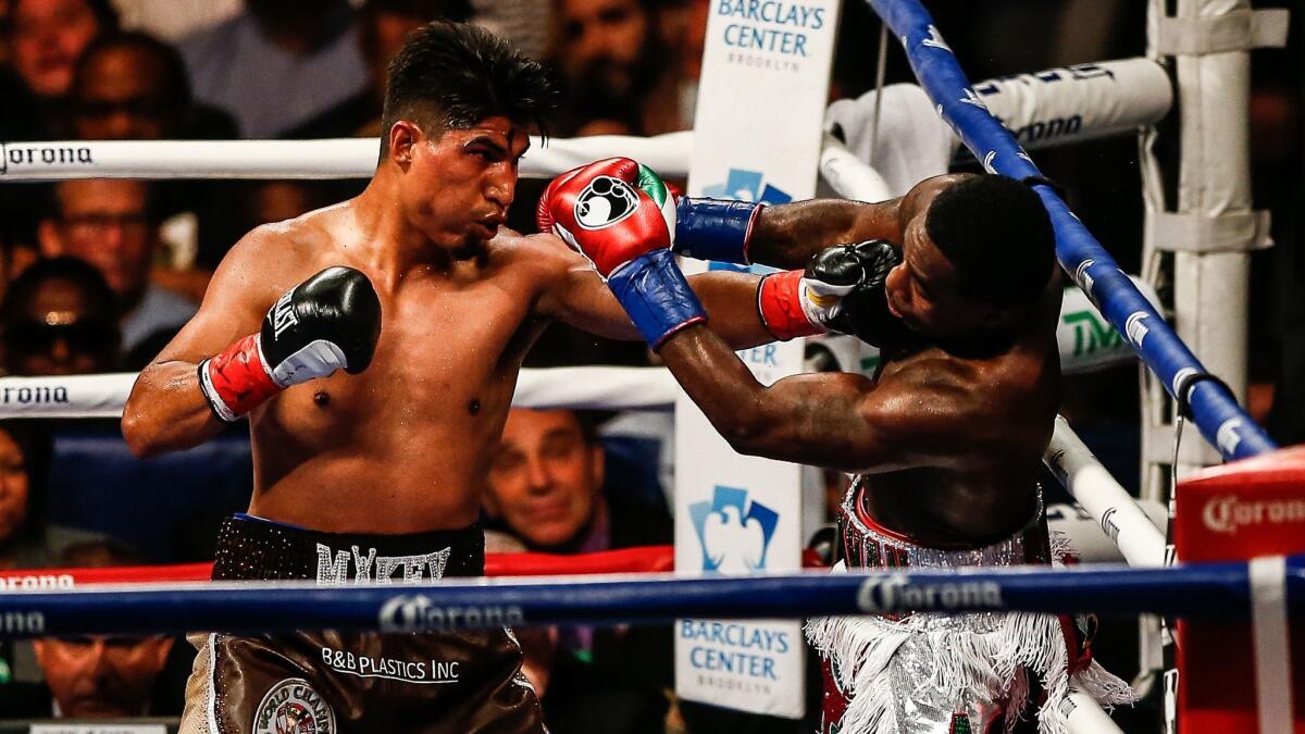 Mikey Garcia, left, and Adrien Broner exchange punches during their junior welterweight title bout in July 2017.
