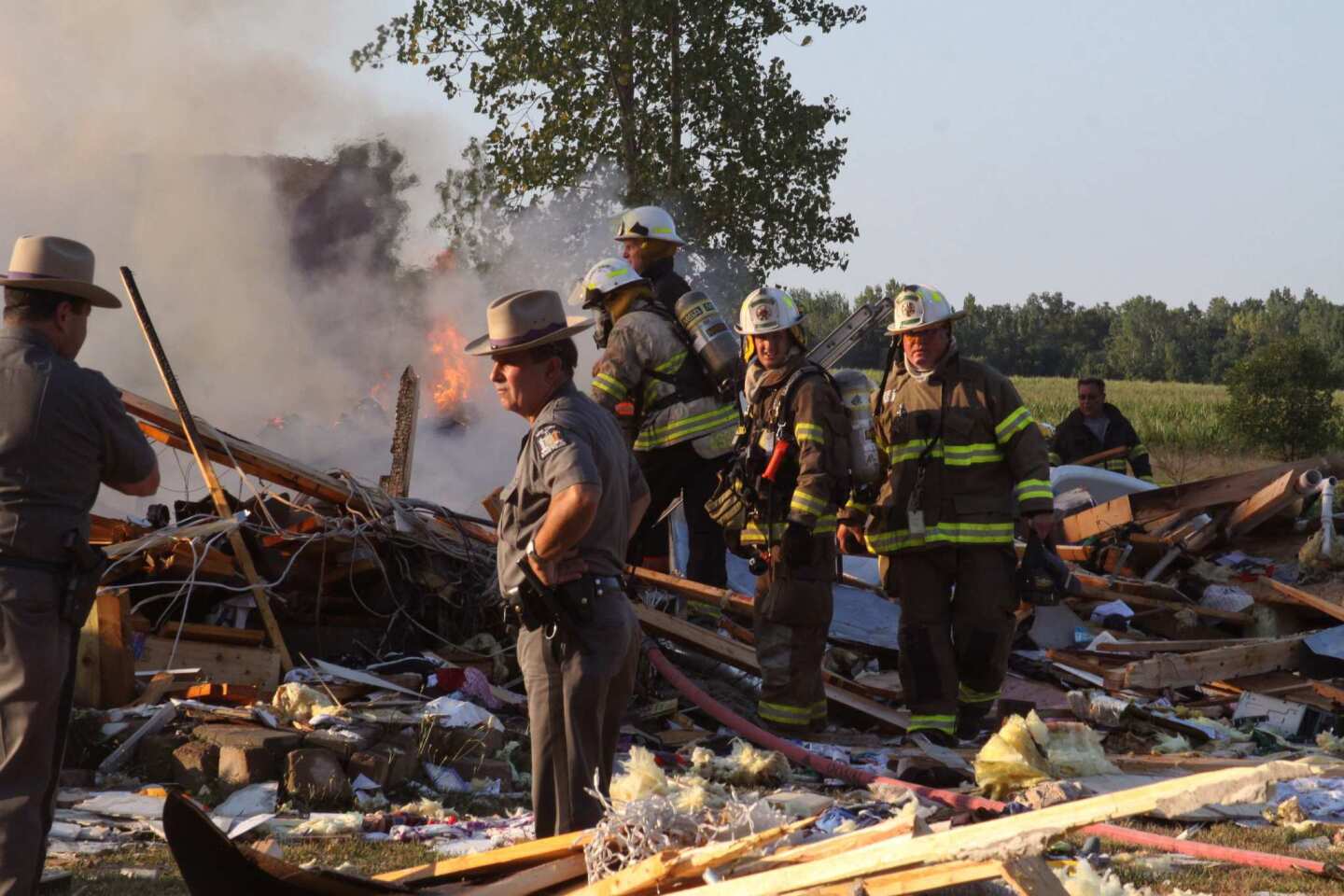 Sheriff's deputies and firefighters look for clues at the scene of a home that exploded Tuesday in Wilson, N.Y., about 30 miles from Buffalo.