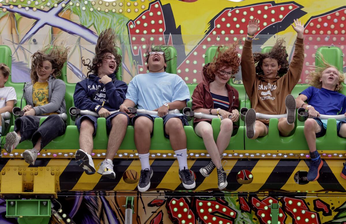 San Diego County Fairgoers ride the Konga on opening day, June 7, 2023.