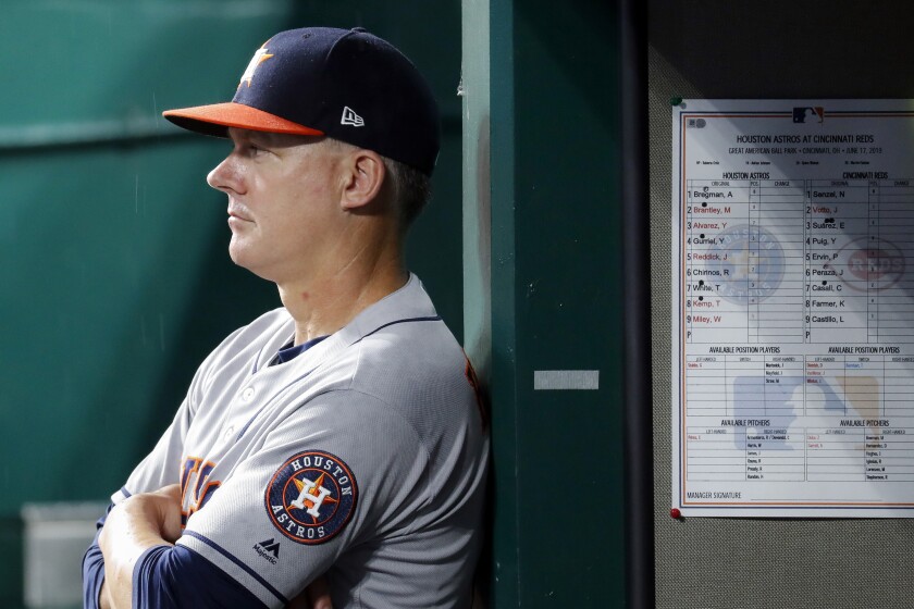 FILE - In this June 17, 2019, file photo, Houston Astros manager AJ Hinch looks on from the dugout in the fifth inning of a baseball game against the Cincinnati Reds in Cincinnati. The AL champions have been dogged by allegations of spying, most recently during this year’s ALCS against the Yankees. Houston players were suspected of whistling in the dugout to communicate pitch selection to batters, an allegation manager AJ Hinch called “ridiculous.” (AP Photo/John Minchillo, File)