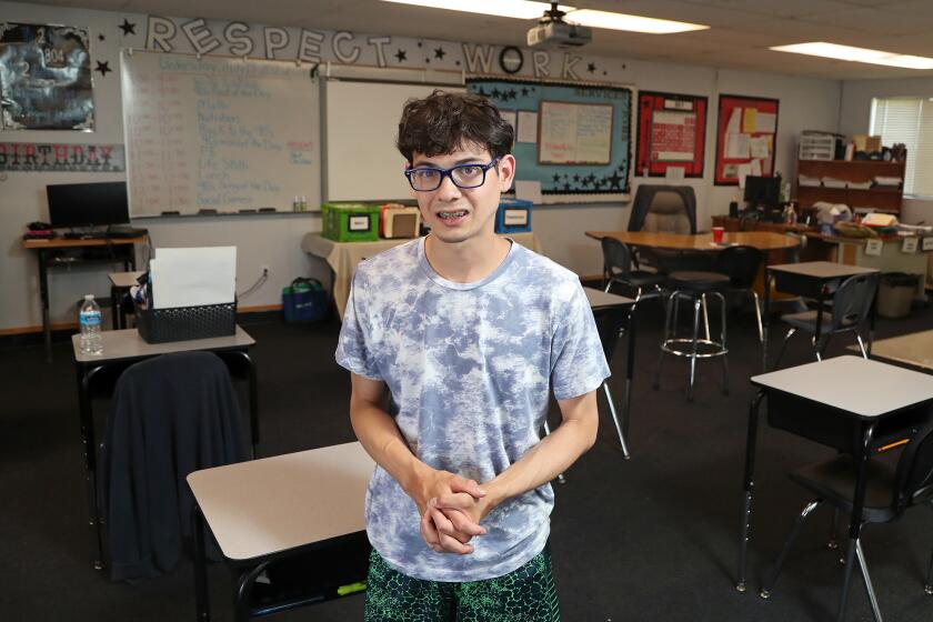 BUENA PARK, CA - July 12: Alumnus Josh Manso, 22, of Long Beach, poses for a portrait in his former classroom at the Speech and Language Development Center on Wednesday, July 12, 2022 in Buena Park, CA. Manso graduated from this center in June 2019. He is currently a student at Cerritos College studying child development. (Kevin Chang / TimesOC)
