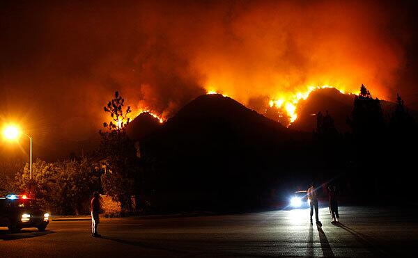 A brush fire above La Canada Flintridge moves down a canyon toward Angeles Crest Highway just before midnight Thursday.