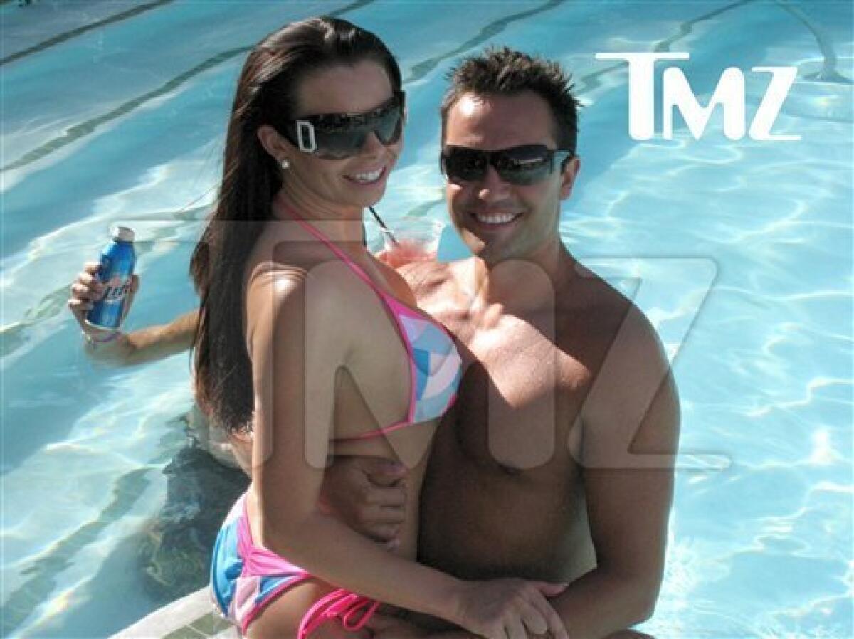 This August 2009 photo provided by TMZ, shows Jasmine Fiore, left, and her husband Ryan Alexander Jenkins in Las Vegas. Jenkins, a reality TV contestant, is charged with killing his wife, a former swimsuit model. (AP Photo/TMZ)