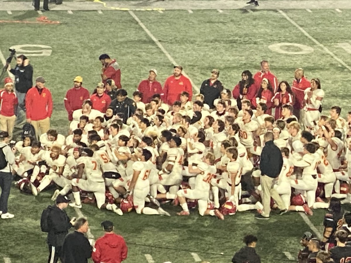 San Diego Cathedral players celebrate on the field after defeating Orange Lutheran.