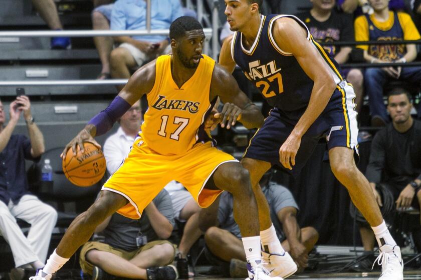 Utah Jazz center Rudy Gobert (27) defends Los Angeles Lakers center Roy Hibbert (17) during the third quarter of a preseason NBA basketball game in Honolulu.