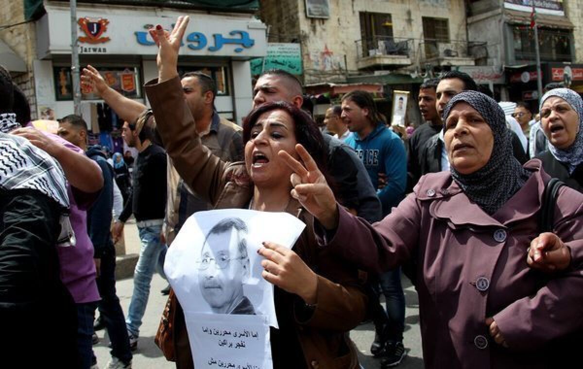 Palestinians take part a protest in the West Bank city of Nablus on Tuesday after the news of the death of Maysara abu Hamdieh in the Israeli Soroka hospital.