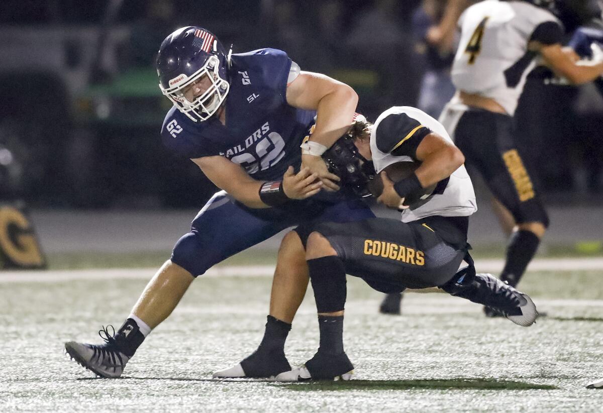 Newport Harbor defensive lineman Nathan Peters sacks Capo Valley quarterback Trey Kukuk during Friday's game.