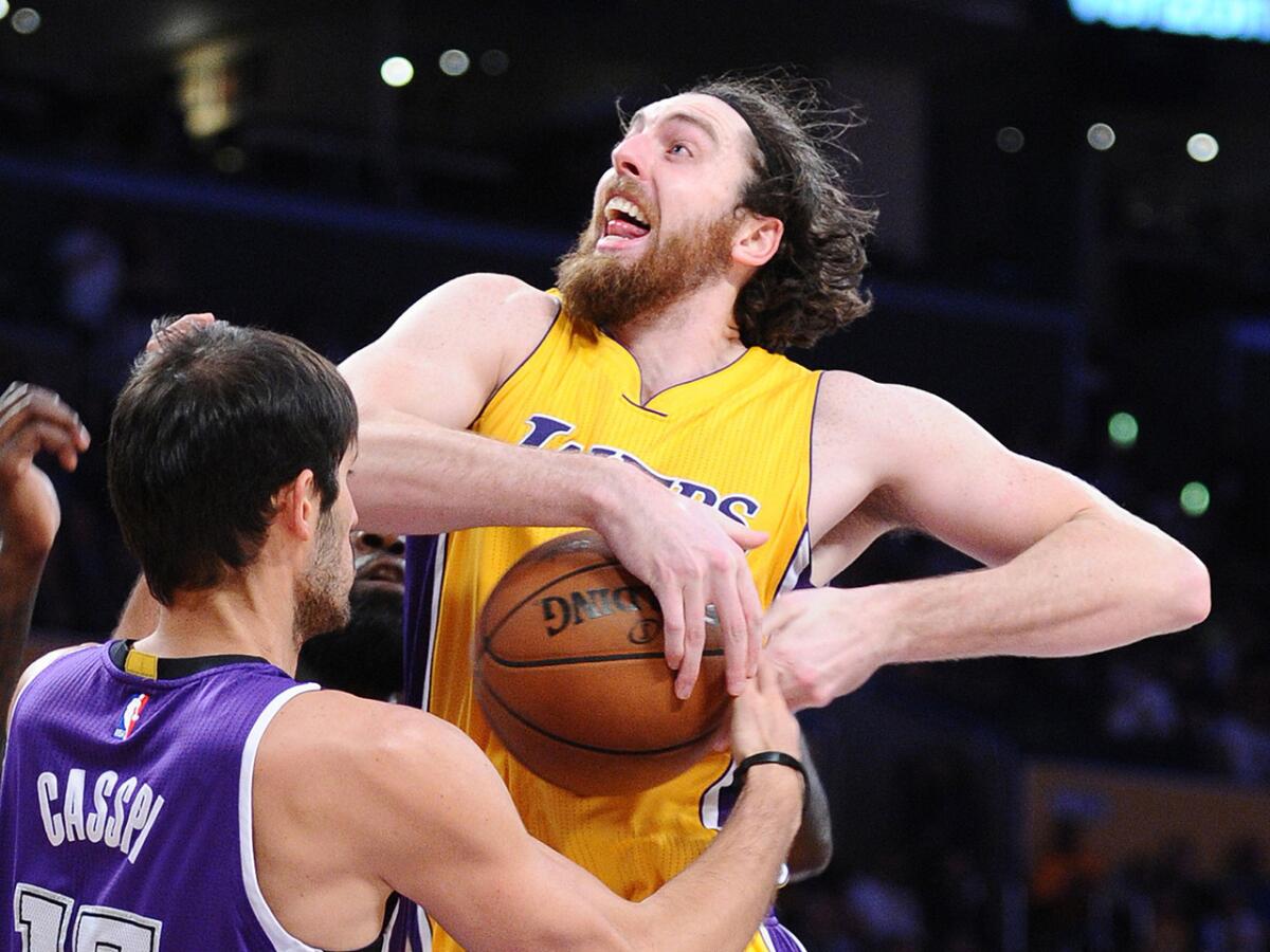 Lakers forward Ryan Kelly is stripped of the ball by Kings forward Omri Casspi during a game on March 15 at Staples Center.