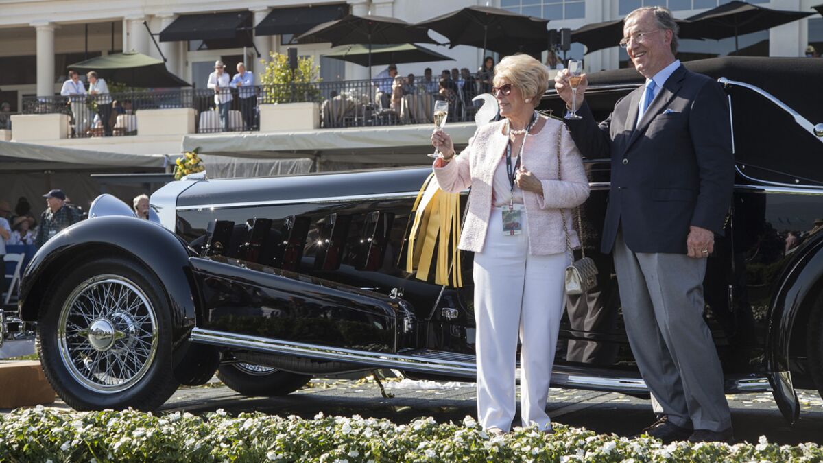 Jim and Dot Patterson lift a glass in celebration of their best of show win at the 65th Annual Pebble Beach Concours d'Elegance, for their 1924 Isotta Fraschini Tipo 8A.