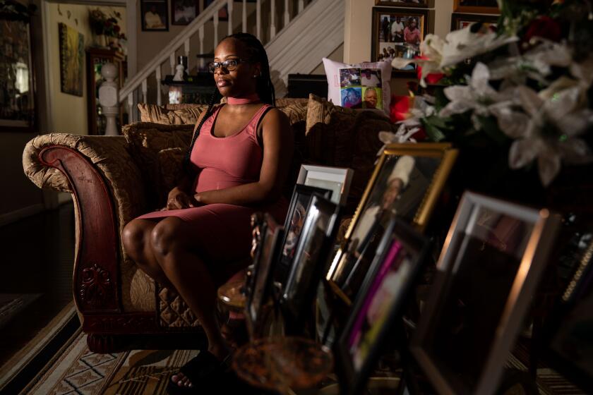 BALTIMORE, MD - SEPTEMBER 21: Brittany Horsey of Baltimore, MD, poses for a portrait in the living room of her Grandmother's home on Tuesday, Sept. 21, 2021 in Baltimore, MD. Horsey was prescribed a drug called Makena during her pregnancies with two children because her doctor believed she was at risk of having them too soon - yet both times the drug didn't work: the babies were born prematurely and Horsey still suffered from Makena's side effects, including being hit by migraines and depression. The FDA has asked Makena's maker to remove the drug from the market because repeated studies have shown it does not work, but the company has refused and continues to promote it. (Kent Nishimura / Los Angeles Times)