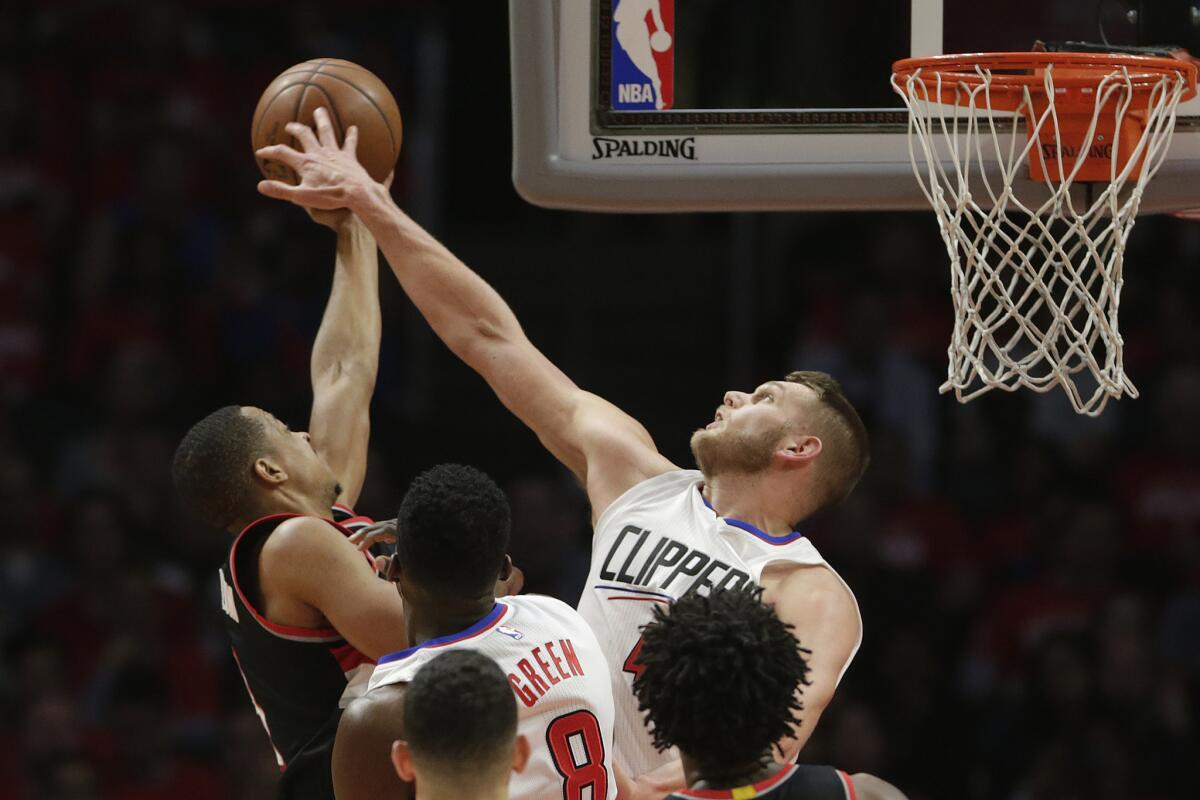 Clippers center Cole Aldrich blocks the shot of Trail Blazers guard C.J. McCollum during the first half of Game 2.