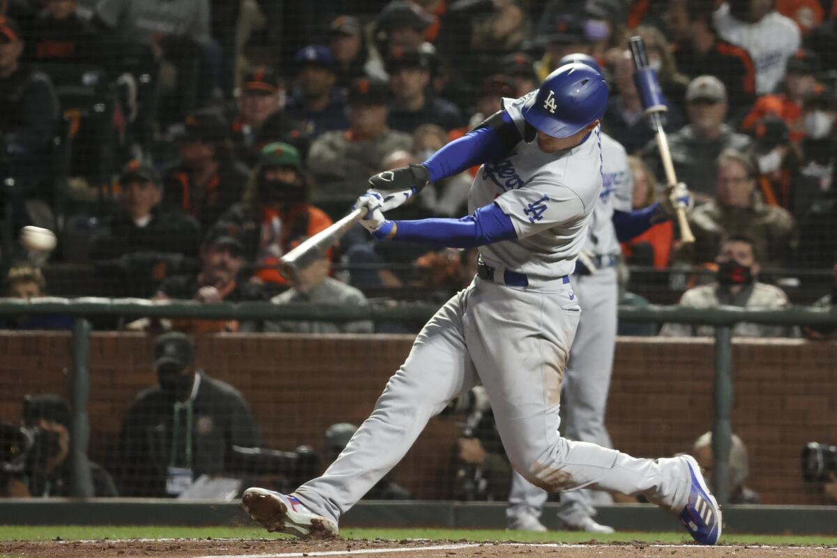 Dodgers batter Cody Bellinger hits a double against the San Francisco Giants on Friday.