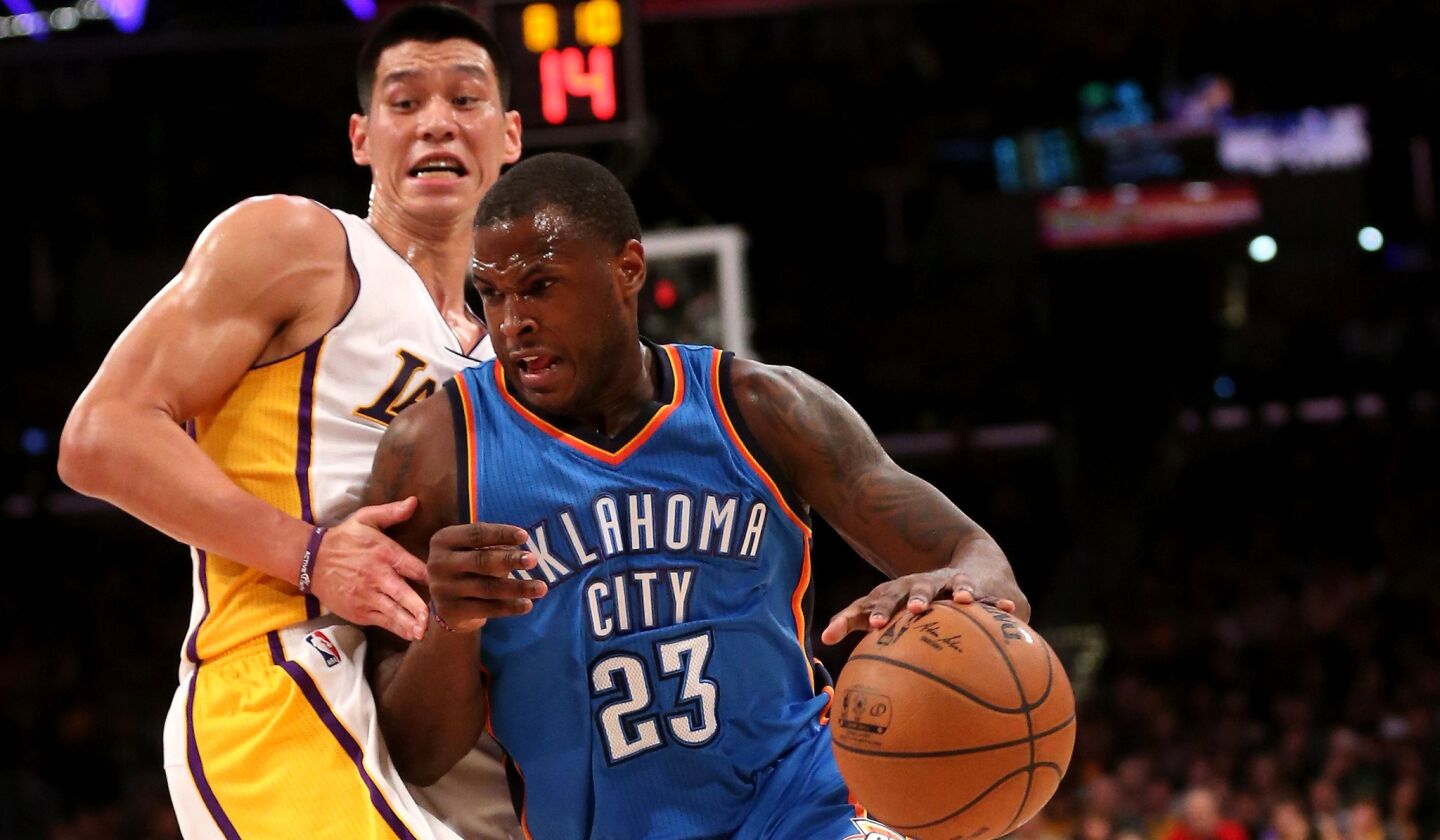 Thunder guard Dion Waiters tries to drive past Lakers point guard Jeremy Lin in the first half Sunday at Staples Center.