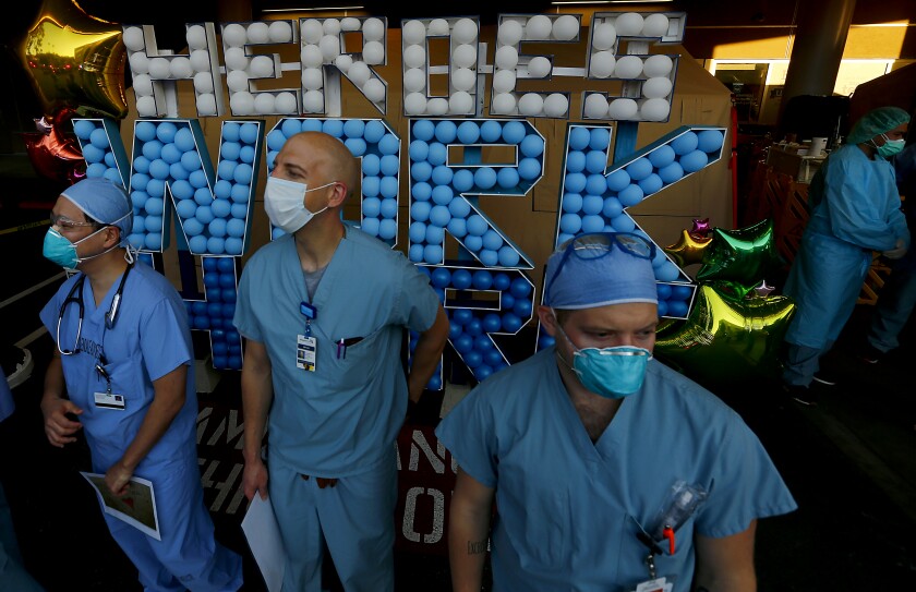 Healthcare workers at Glendale Adventist Hospital gather outside Tuesday for a tribute to their work by Glendale police and fire first responders.