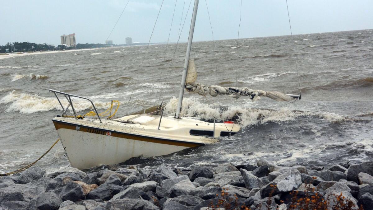An abandoned boat takes on water on the Mississippi Gulf Coast on Saturday near Biloxi, Miss., as the outer bands of Hurricane Nate begin to batter the shore.